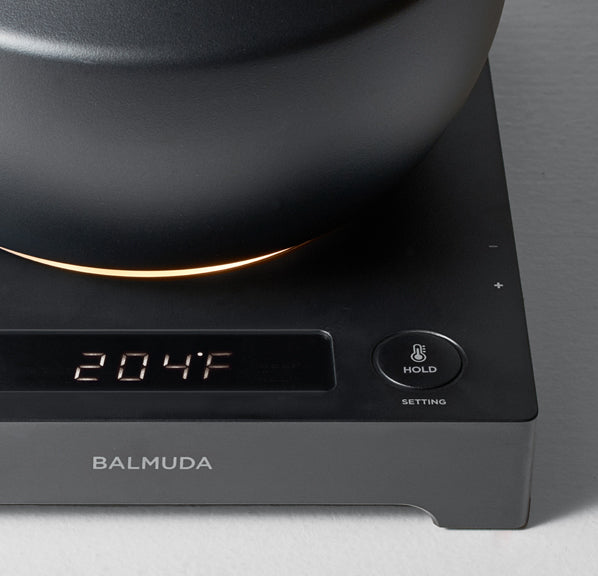 The MoonKettle's digital display shows 204°F, highlighting its temperature hold function and sleek black design.