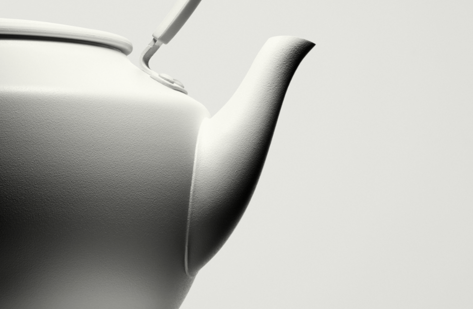 A close-up of a white MoonKettle spout and handle, highlighting its smooth texture and minimalist design against a softly lit background.