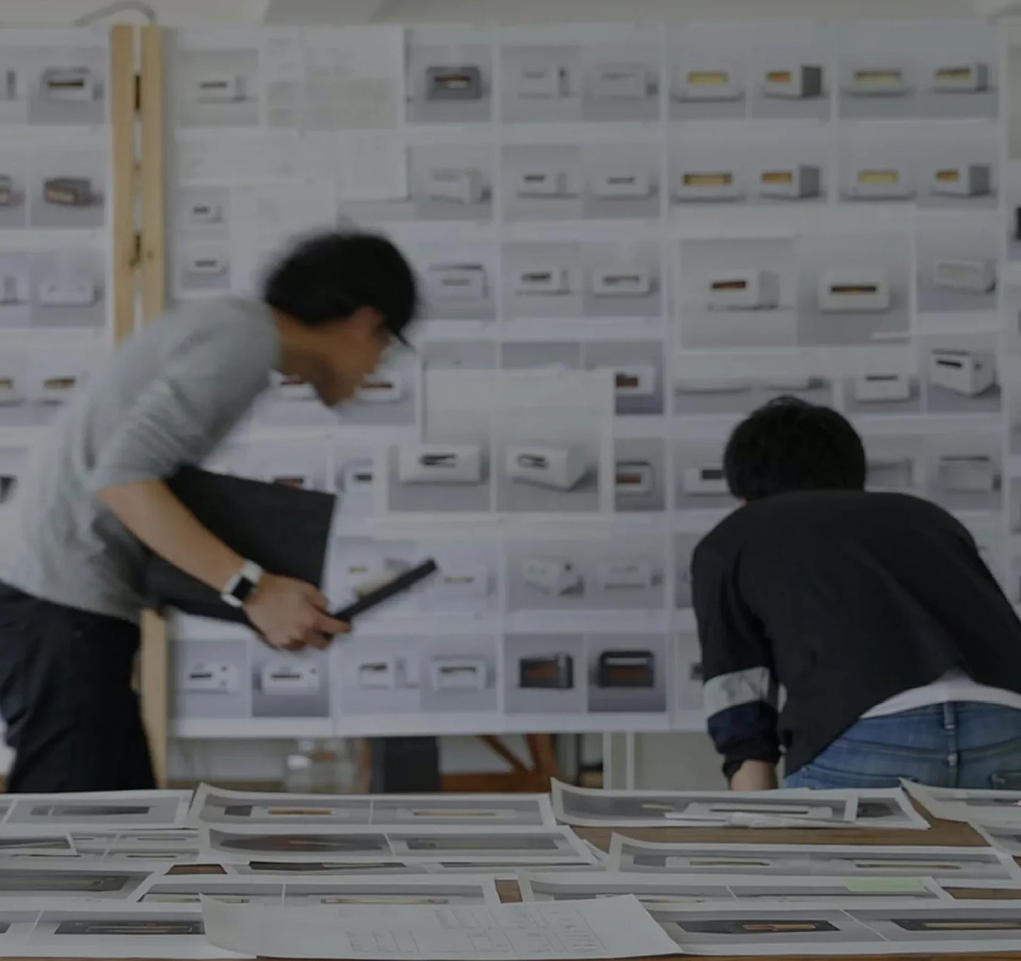 Designers reviewing multiple designs for The Toaster.