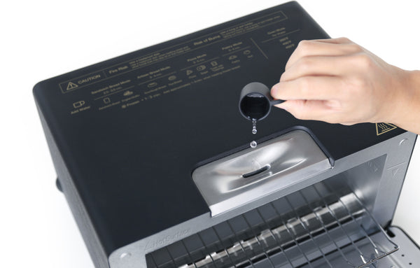Black the toaster, top view, with water being added