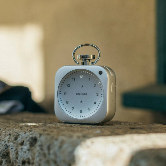 The Clock placed against an outdoor stone wall